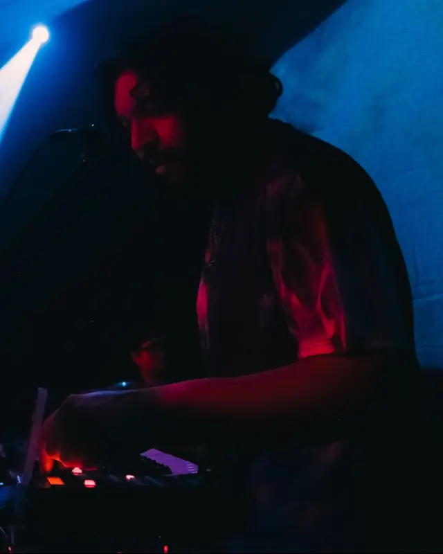 Cami tocando teclado bajo luz roja y azul